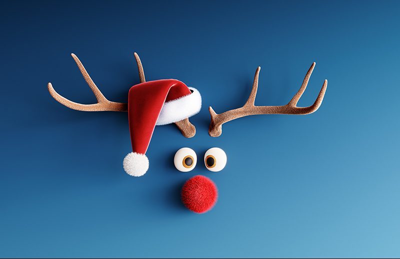 Reindeer with red nose and Santa hat on blue Christmas backgroun
